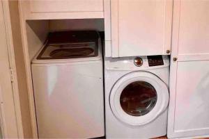 a washing machine and a washer in a kitchen at 2 Bedroom Luxury Home.. Wooden Floors and Ceilings in Dallas