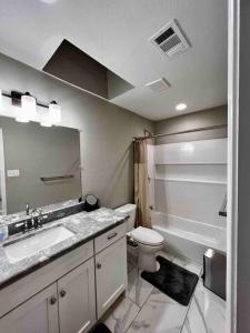 a bathroom with a sink and a toilet at 2 Bedroom Luxury Home.. Wooden Floors and Ceilings in Dallas