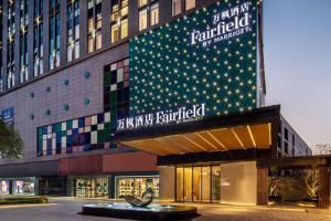 a building with christmas lights on the side of it at Fairfield by Marriott Huai'an Downtown in Huai'an