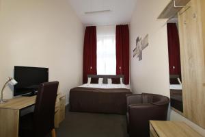 TV a/nebo společenská místnost v ubytování Hotel Elegia am Kurfürstendamm