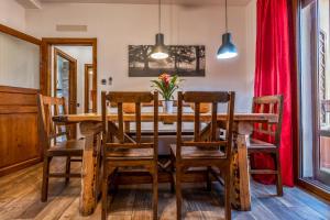 a dining room with a wooden table and chairs at B&B Selvarossa in Bologna
