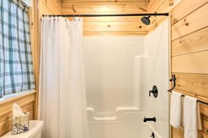 a bathroom with a shower with a white shower curtain at Maine Cabin Rental on Rangeley Lake! in Rangeley +25 photos