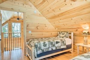 um quarto com uma cama num chalé de madeira em Maine Cabin Rental on Rangeley Lake! em Rangeley