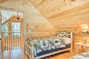 a bedroom with a bed in a log cabin at Maine Cabin Rental on Rangeley Lake! in Rangeley