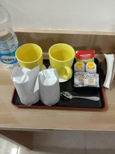 a tray with cups and other items on a shelf at Dev Residency in Gurgaon