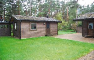a small cabin in a yard with a green lawn at 4 Bedroom Lovely Home In Borrby in Borrby