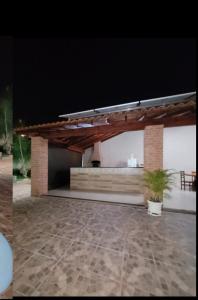 a pavilion with a table and a potted plant in a patio at Recanto Fernanda in Olímpia