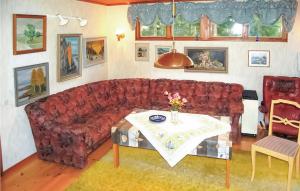 a living room with a red couch and a table at Holiday Home Curt Ols Väg Borrby in Borrby