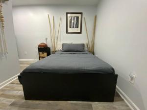a bed in a room with a black mattress at Artistic luxury home downtown/train to NYC/AirPort in Newark