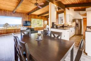 a kitchen and dining room with a table and chairs at Ocean Vista Gold Beach Getaway! in Gold Beach