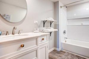 a white bathroom with a sink and a mirror at Ocean Vista Gold Beach Getaway! in Gold Beach