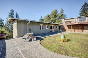 a building with a picnic table in front of it at Ocean Vista Gold Beach Getaway! in Gold Beach