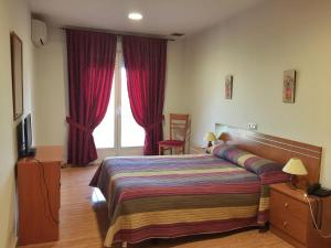 Posteľ alebo postele v izbe v ubytovaní Hotel Godofredo