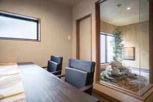 a room with a table and chairs and a large mirror at Samurai Suite 1 , 15mins from Kyoto Eki , 5 mins to Arashiyama in Kyoto +6 photos