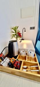 a wooden tray with utensils on a table at Seaside Dhigurah in Dhigurah