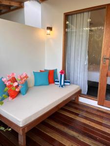 a bench sitting in a room with a window at Seaside Dhigurah in Dhigurah