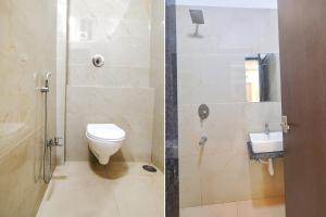 a bathroom with a shower with a toilet and a sink at FabHotel Ramya in Indore