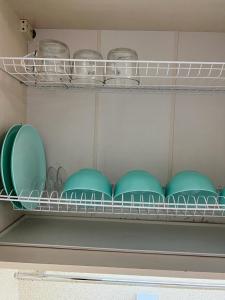 a shelf with plates and bowls on it at Квартира бизнес класса in Semey