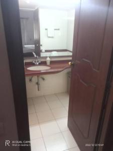a bathroom with a sink and a mirror at West Valley Villa, Casa Bliss in Marmagao