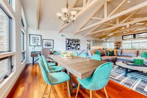 a dining room with a wooden table and blue chairs at Westbrook Wonder in Austin