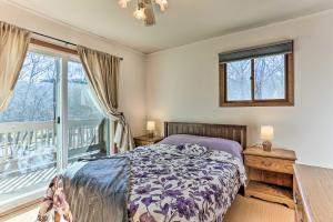 a bedroom with a bed and a large window at Poconos Retreat, 6 Mi to Shawnee Mountain Ski Area in East Stroudsburg