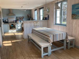 a kitchen with a table and a bench in a room at Maison Bangor, 5 pièces, 6 personnes - FR-1-418-228 in Bangor