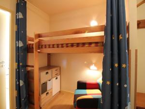 a bedroom with two bunk beds and a desk at Appartement La Bourboule, 2 pièces, 5 personnes - FR-1-608-243 in La Bourboule