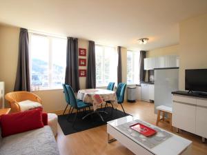 a living room with a table and chairs and a kitchen at Appartement La Bourboule, 2 pièces, 5 personnes - FR-1-608-243 in La Bourboule