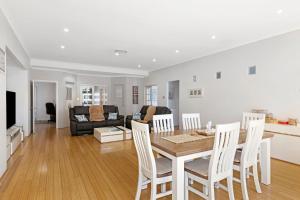 a dining room and living room with a table and chairs at Baudins of Busselton Bed and Breakfast - Adults only in Busselton