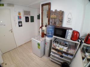 a kitchen with a small refrigerator and a microwave at Pensión La Estación in Logroño