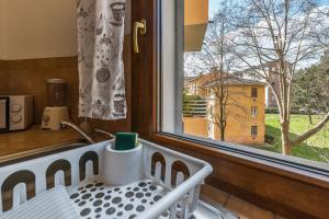 wieszak na naczynia w kuchni z oknem w obiekcie B&B Selvarossa w Bolonii