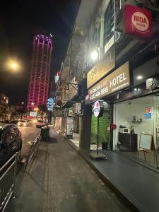 a city street at night with a hotel at G99 Hotel in George Town