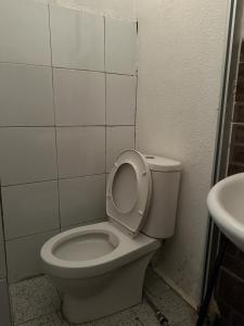 a bathroom with a white toilet and a sink at G99 Hotel in George Town