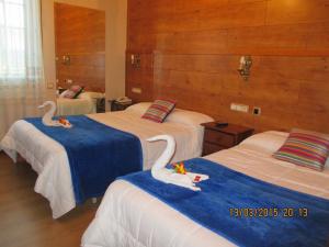 Łóżko lub łóżka w pokoju w obiekcie Hotel Playa Samil Vigo