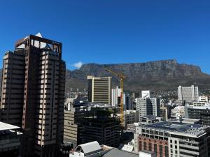 a view of a city with a mountain in the background at Urban Elephant 16 On Bree in Cape Town