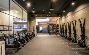 a gym with a bunch of exercise equipment on the wall at La Casa hotel Gwangmyeong in Gwangmyeong