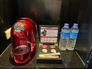 a red toaster next to two bottles of water at 安庭台北商旅 in Taipei