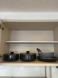 three pans sitting on a shelf in a kitchen at 500m Sta .7人PPL. FREE PORTABLE WIFI ,NEAR SUPER MARKET in Shin-kotoni