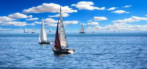 a group of sailboats floating in the water at Tinyhouses am Neusiedlersee in Fertőrákos
