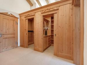 a large closet with wooden walls and wooden doors at Exclusive Tyrolean Chalet near Ski lifts in Apfeldorf +31 photos