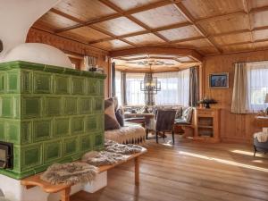 a living room with a green fireplace in a house at Exclusive Tyrolean Chalet near Ski lifts in Apfeldorf