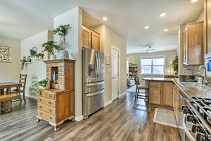 a kitchen with stainless steel appliances and wooden cabinets at Gypsum Home with Patio Between Glenwood and Vail in Eagle