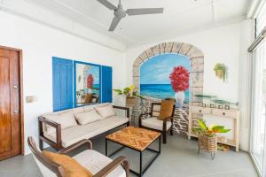 a living room with a couch and a table at Exclusive Cliff House with Pool and Beach Access in Dumanjug