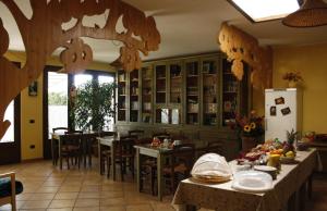 a kitchen with tables and chairs and a refrigerator at Le Storie di Bambu in Terni