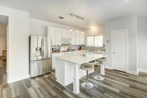 a kitchen with a white counter and a refrigerator at Houston Vacation Rental with Private Yard! in Houston