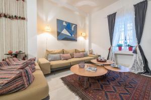 a living room with a couch and two tables at Athenian Niche in Plaka Villa by Athenian Homes in Athens