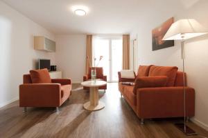 a living room with two chairs and a table at Exquisit 3 in Norderney
