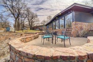 a patio with two chairs and a table in front of a house at Lake Hudson Home with Patio in Locust Grove in Locust Grove