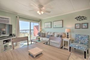 a living room with a couch and a table at End-Unit Ocean City Condo with Panoramic Views! in Ocean City