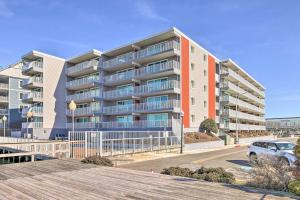 a large apartment building on a street with a parking lot at End-Unit Ocean City Condo with Panoramic Views! in Ocean City